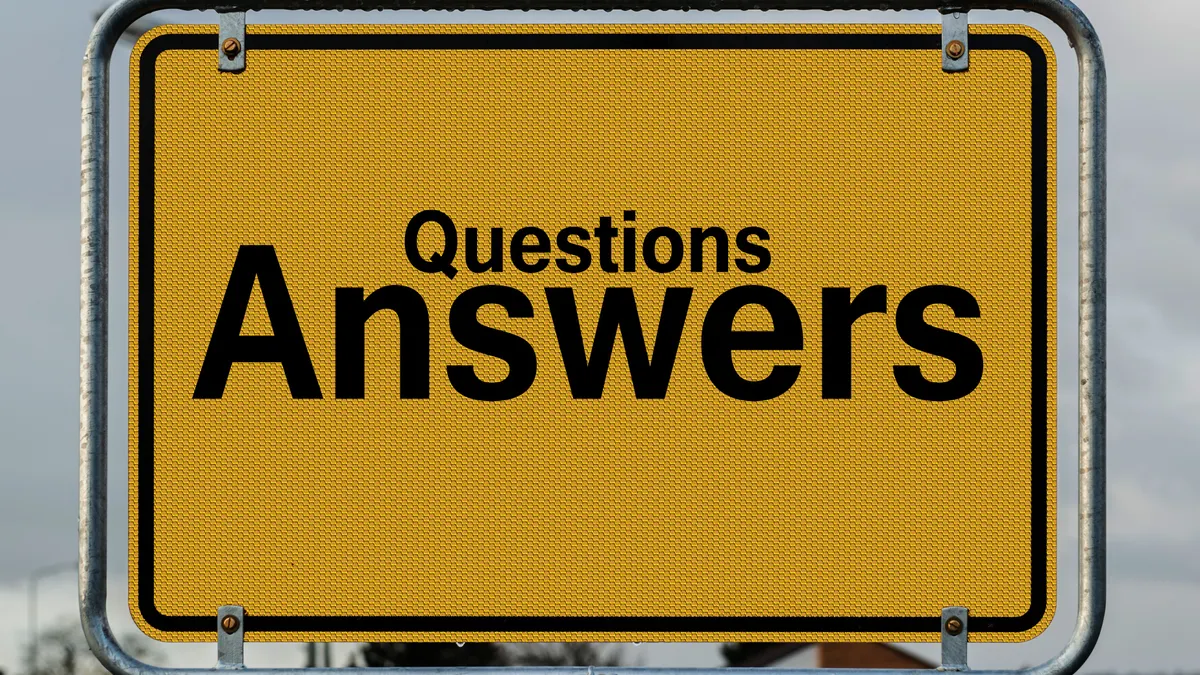Yellow sign reading Questions Answers