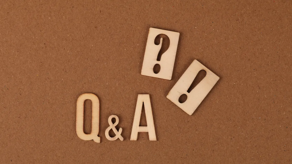 Wooden Q&A letters with punctuation symbols on a brown background