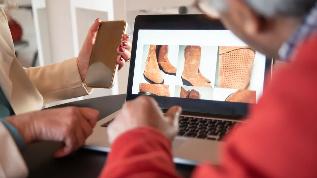 People viewing shoe products on a laptop