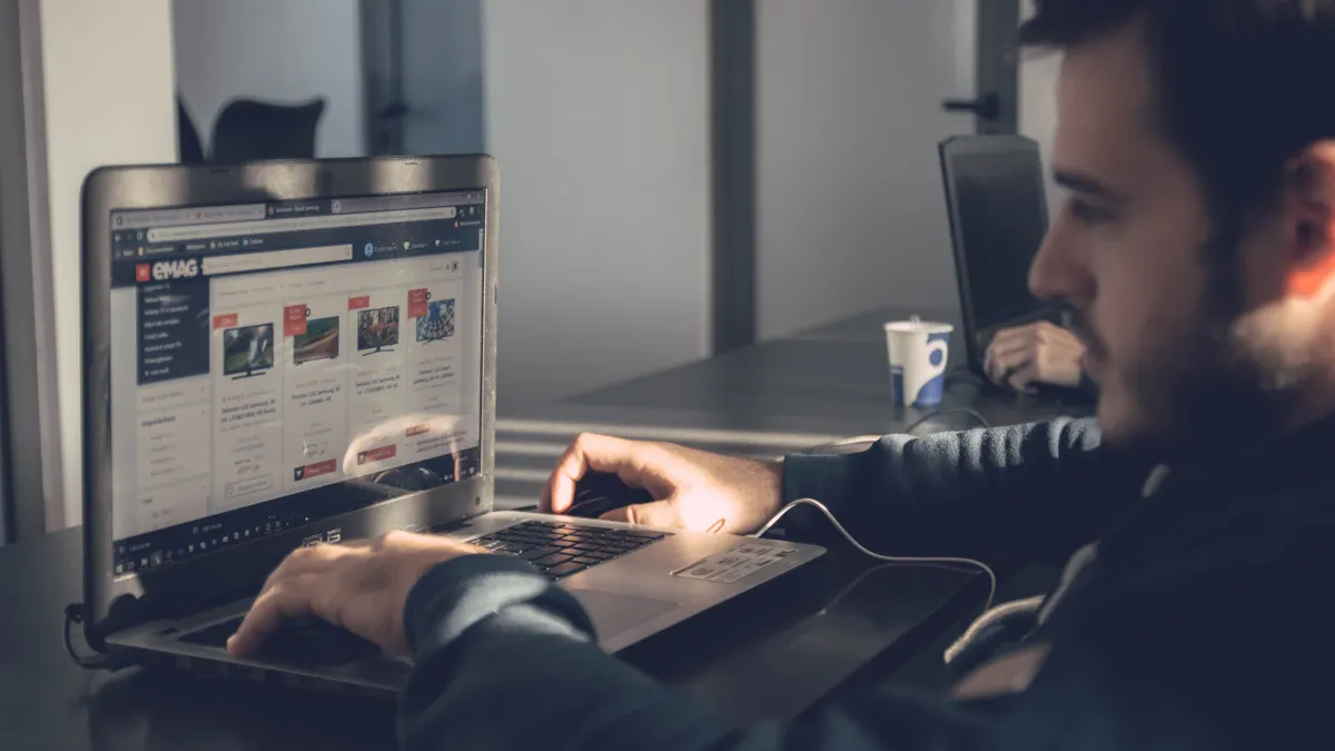 Man using laptop with an e-commerce page
