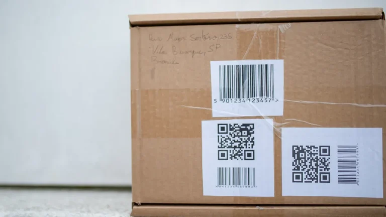 Cardboard shipping box with barcode and QR code labels