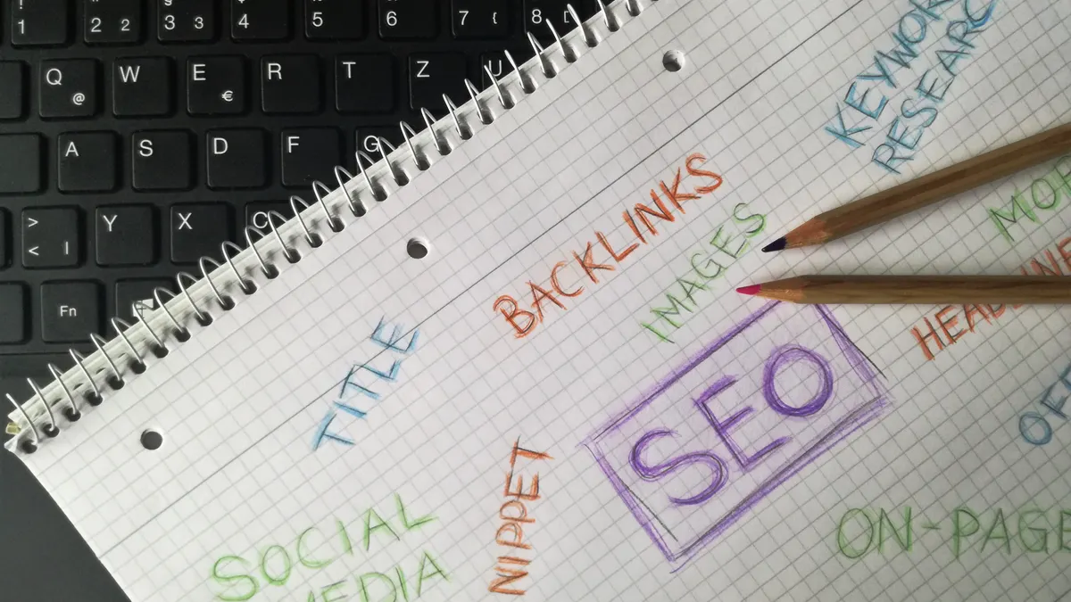 Notebook with SEO and backlinks notes beside a keyboard
