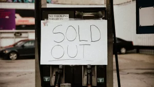 Handwritten SOLD OUT sign on a storefront pump